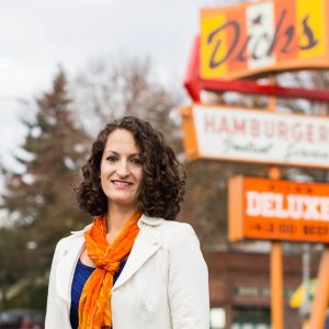 Jasmine Donovan with Dick's Drive-In restaurant sign behind her.