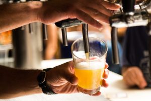 Beer being poured out of a tap.