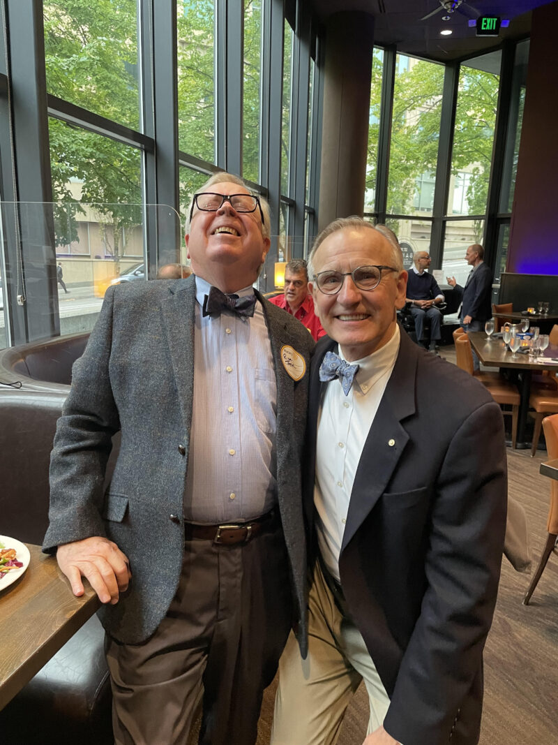 Past president Rick Taylor demonstrates the effect of a tight bow tie